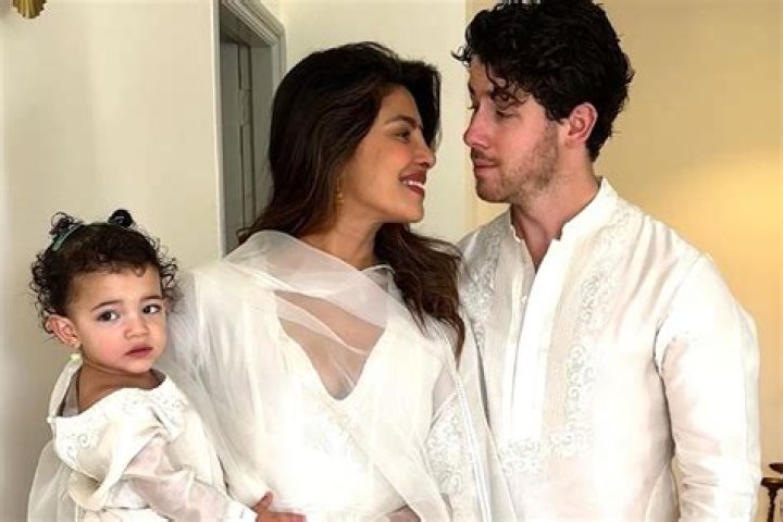 Priyanka Chopra Wraps Her Arms Around Nick Jonas As They Cuddle In Front Of Their Christmas Tree
